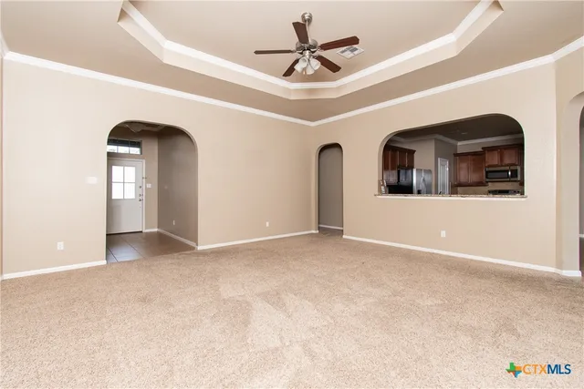 a view of a livingroom with a ceiling fan and window