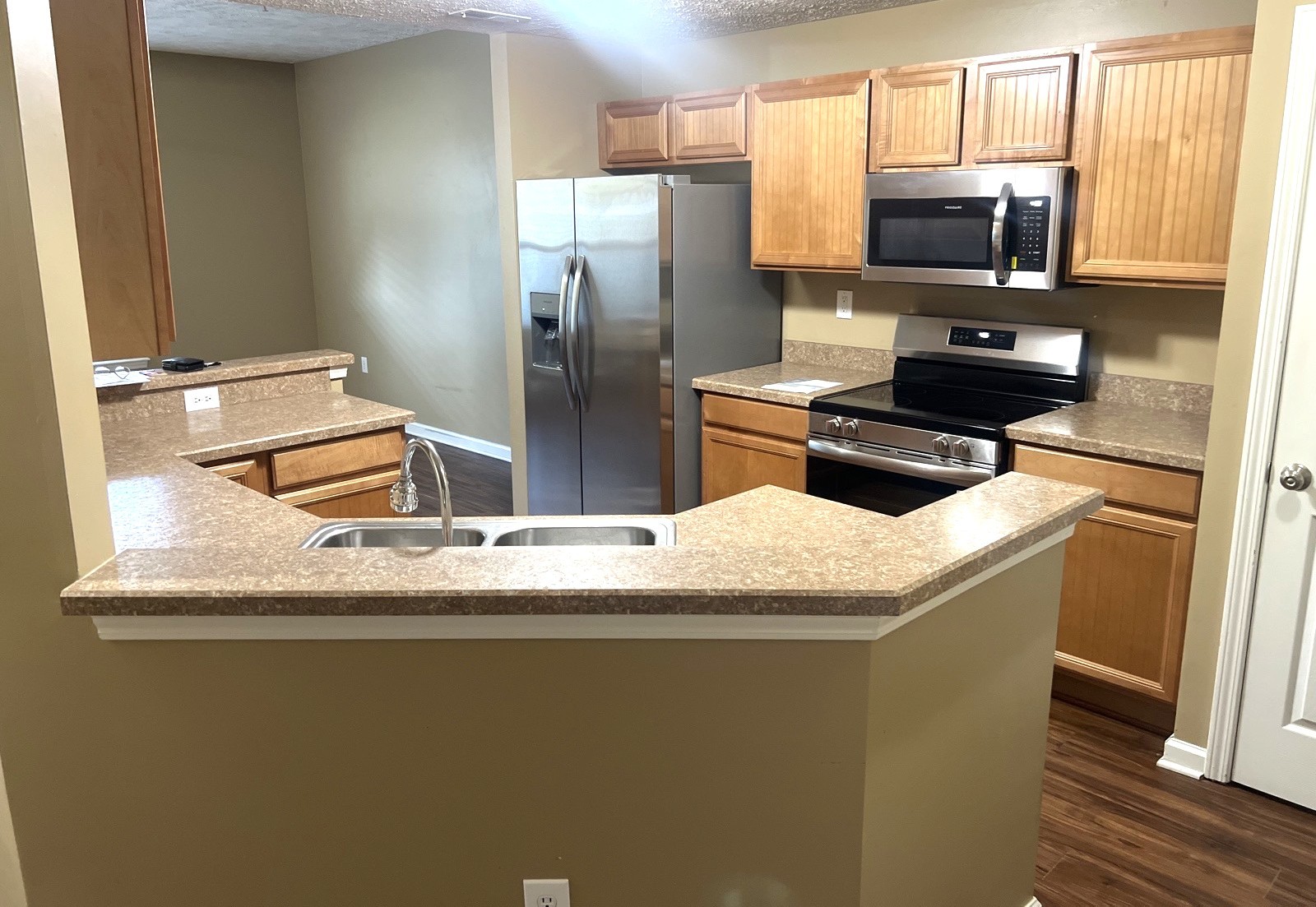 1000 Wells Way Spring Hill, TN 37174 - Photo 5 of 20 a kitchen with granite countertop a refrigerator stove and microwave
