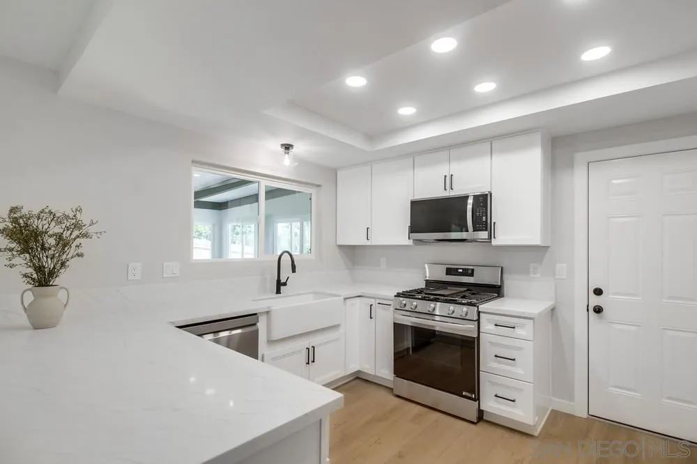8174 Sunset Road Lakeside, CA 92040 - Photo 12 of 46 a kitchen with stainless steel appliances a stove a sink and a microwave