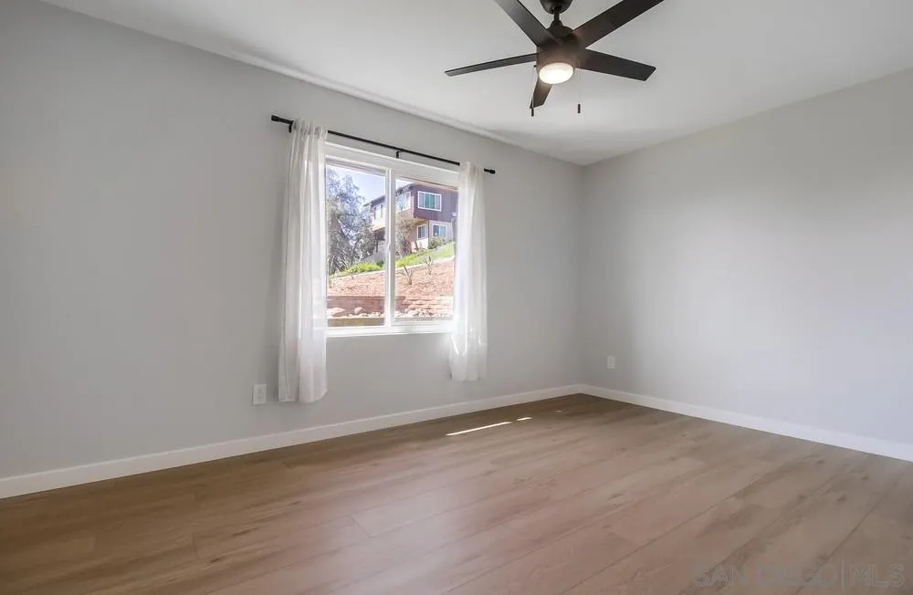 8174 Sunset Road Lakeside, CA 92040 - Photo 29 of 46 wooden floor in an empty room with a window