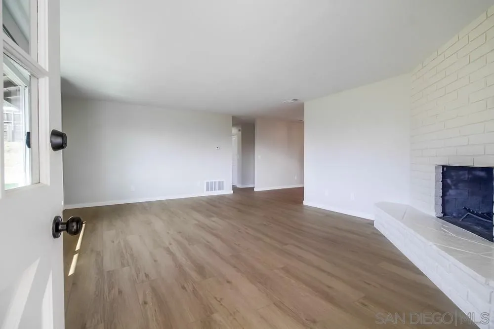 8174 Sunset Road Lakeside, CA 92040 - Photo 5 of 46 an empty room with wooden floor and windows