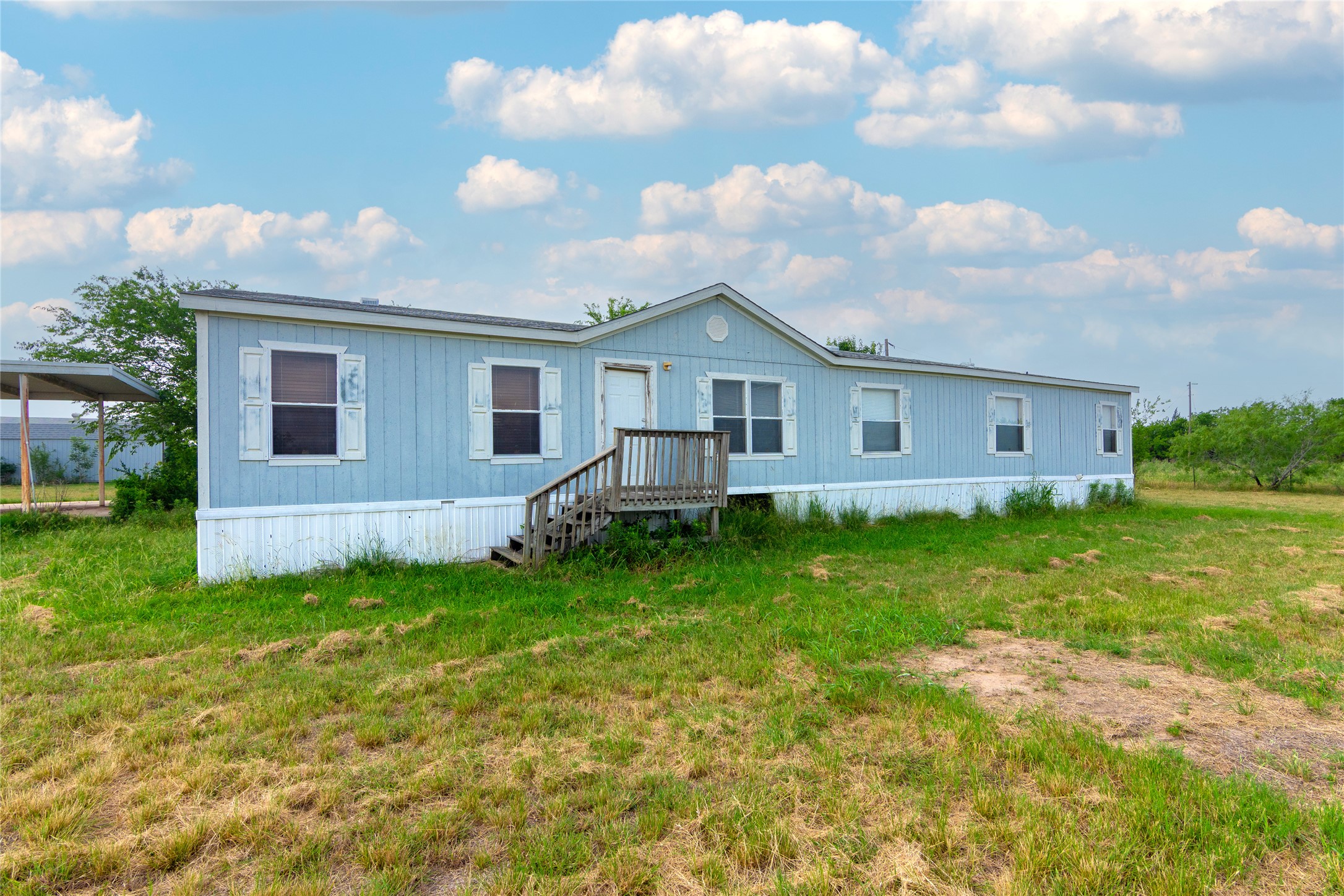 1 11209-tract Road Del Valle, TX 78617 - Photo 6 of 39 Rear view of property featuring a lawn