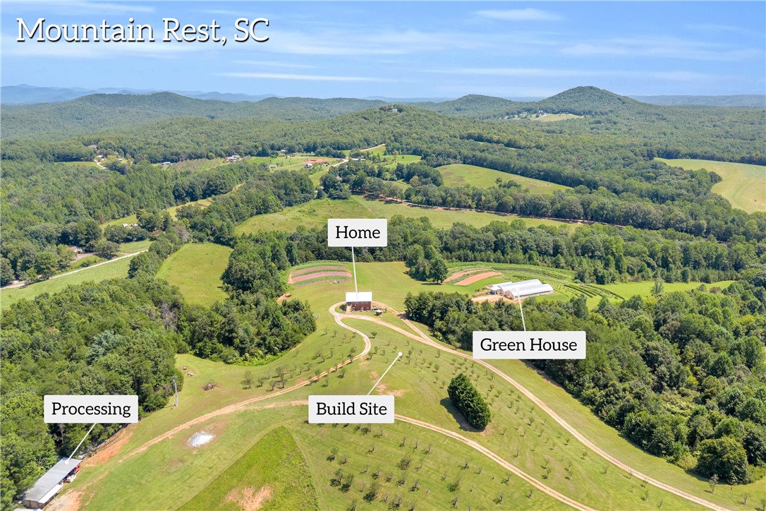 Rolling green hills and majestic mountain ridges frame this expansive countryside acreage.
