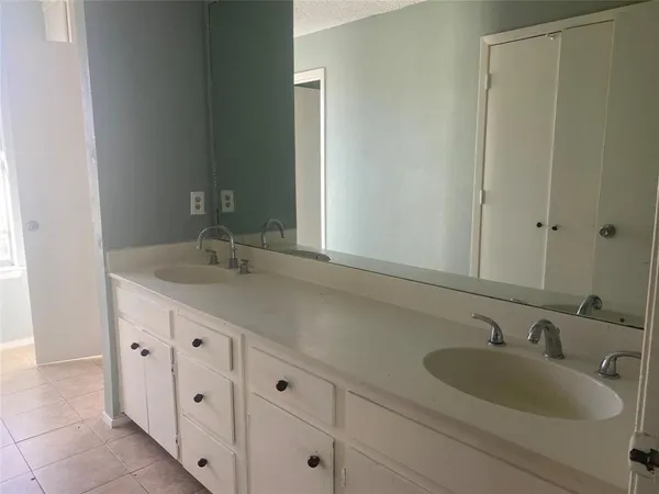 an empty room with a ceiling fan and a window