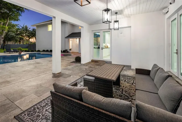 a living room with furniture and a chandelier
