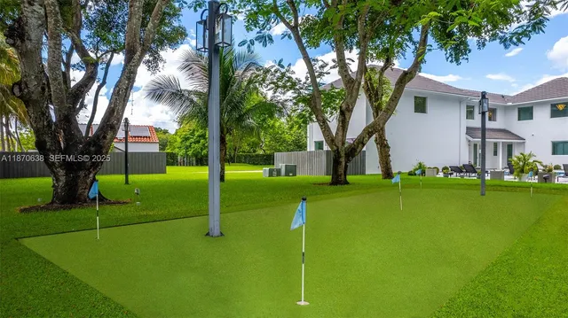a view of a house with pool and a tree
