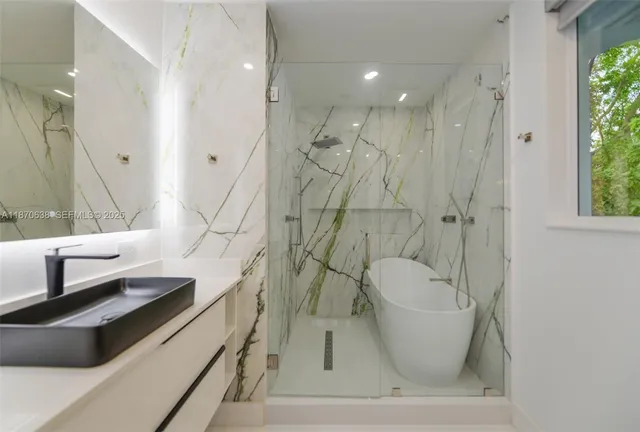 a bathroom with a bathtub and a shower