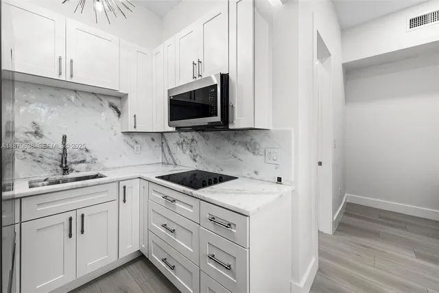 a view of white cabinets and sink