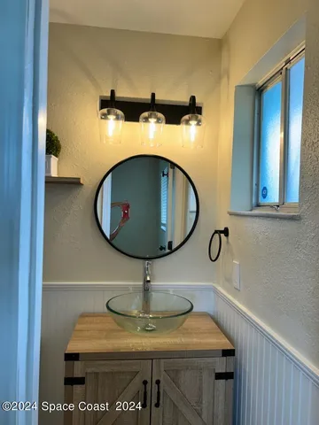 a bathroom with a glass shower door