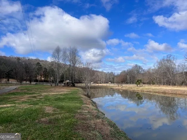 a view of a lake with houses in the back