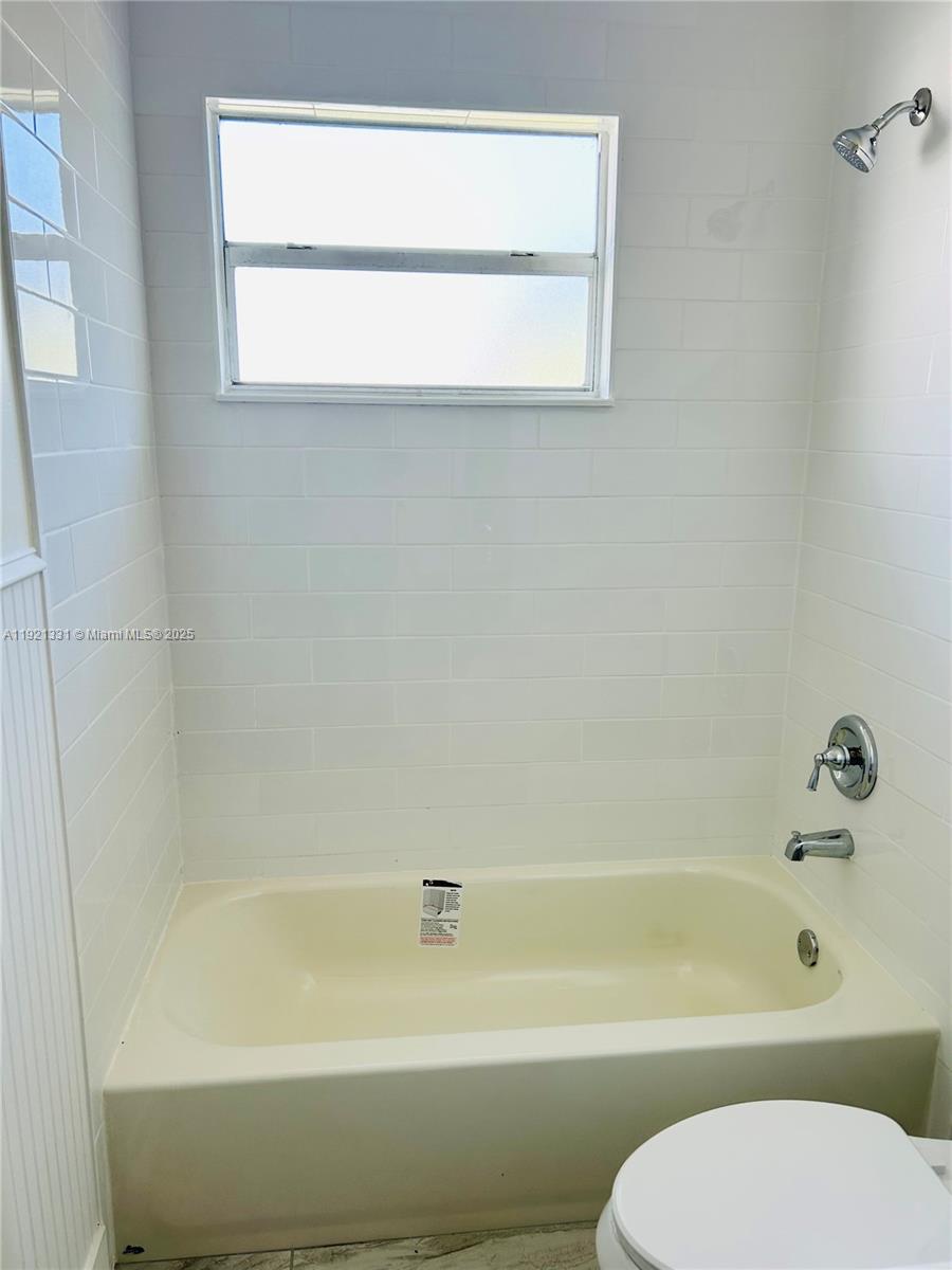 10601 Southwest 184th Street, Unit 10603 Cutler Bay, FL 33157 - Photo 5 of 6 a bathroom with a toilet and a bath tub
