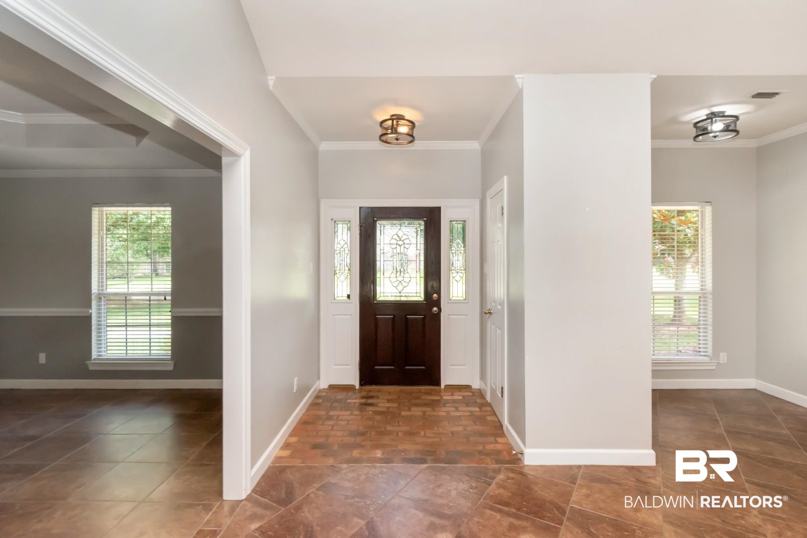 10691 Hunters Ridge Drive Mobile, AL 36695 - Photo 4 of 37 Inviting entryway featuring a dark wood front door with decorative glass side panels, complemented by a tiled floor
