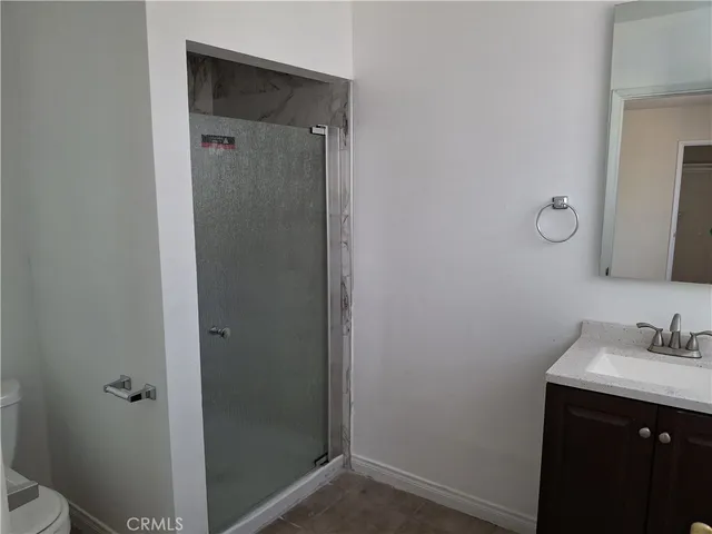 a bathroom with a shower sink and mirror