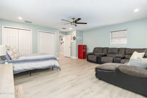 a living room with furniture and a ceiling fan