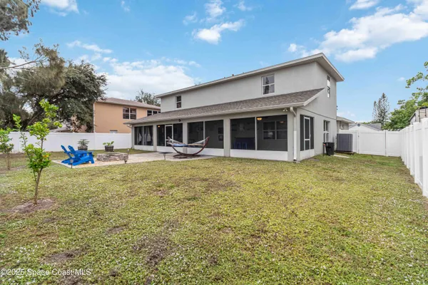 a view of a house with backyard and sitting area