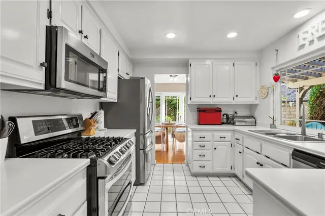 a kitchen with stainless steel appliances granite countertop a stove and a sink