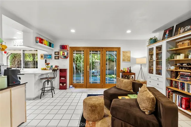 a living room with furniture and a book shelf