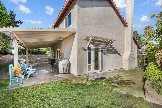 a view of a patio with table and chairs potted plants with wooden fence
