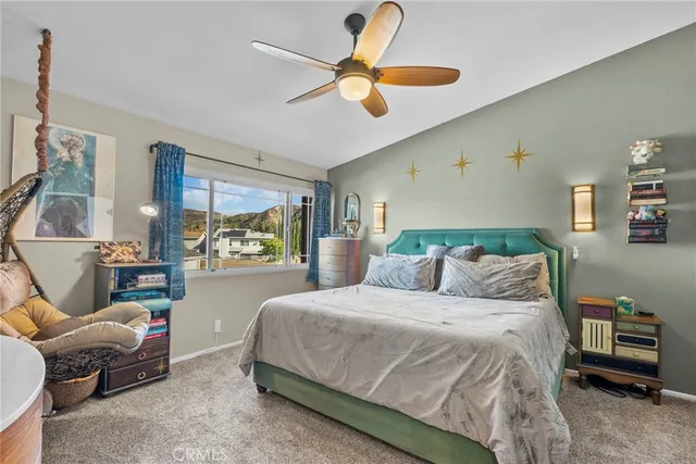 a bedroom with a bed and a large window