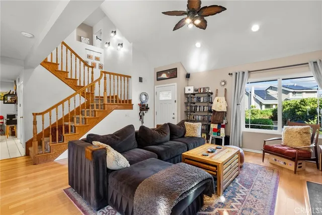 a living room with furniture ceiling fan and a rug