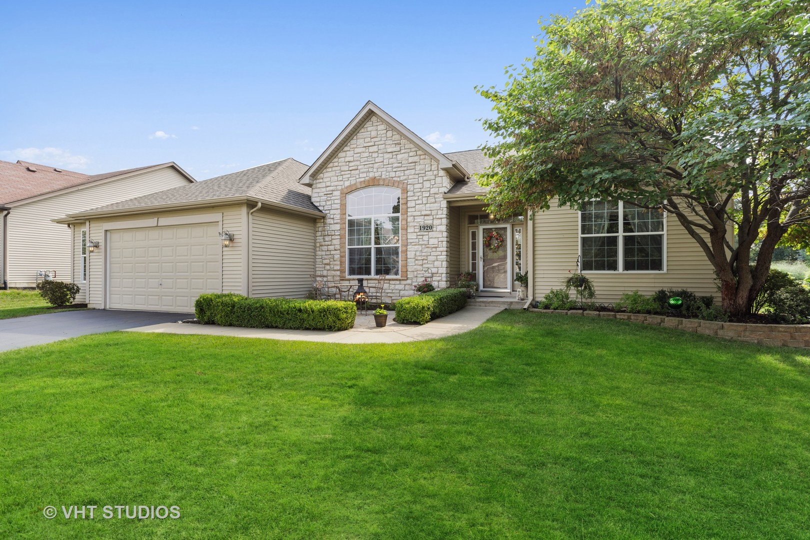 1920 Tyler Trail McHenry, IL 60051 - Photo 1 of 20 a front view of a house with a yard and trees