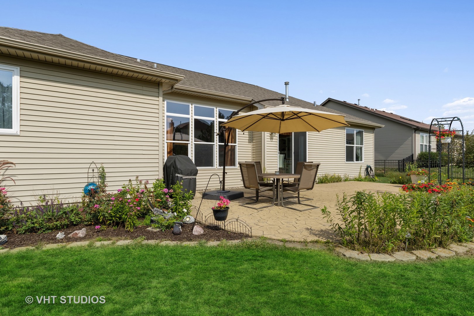 1920 Tyler Trail McHenry, IL 60051 - Photo 19 of 20 a view of a house with backyard sitting area and garden