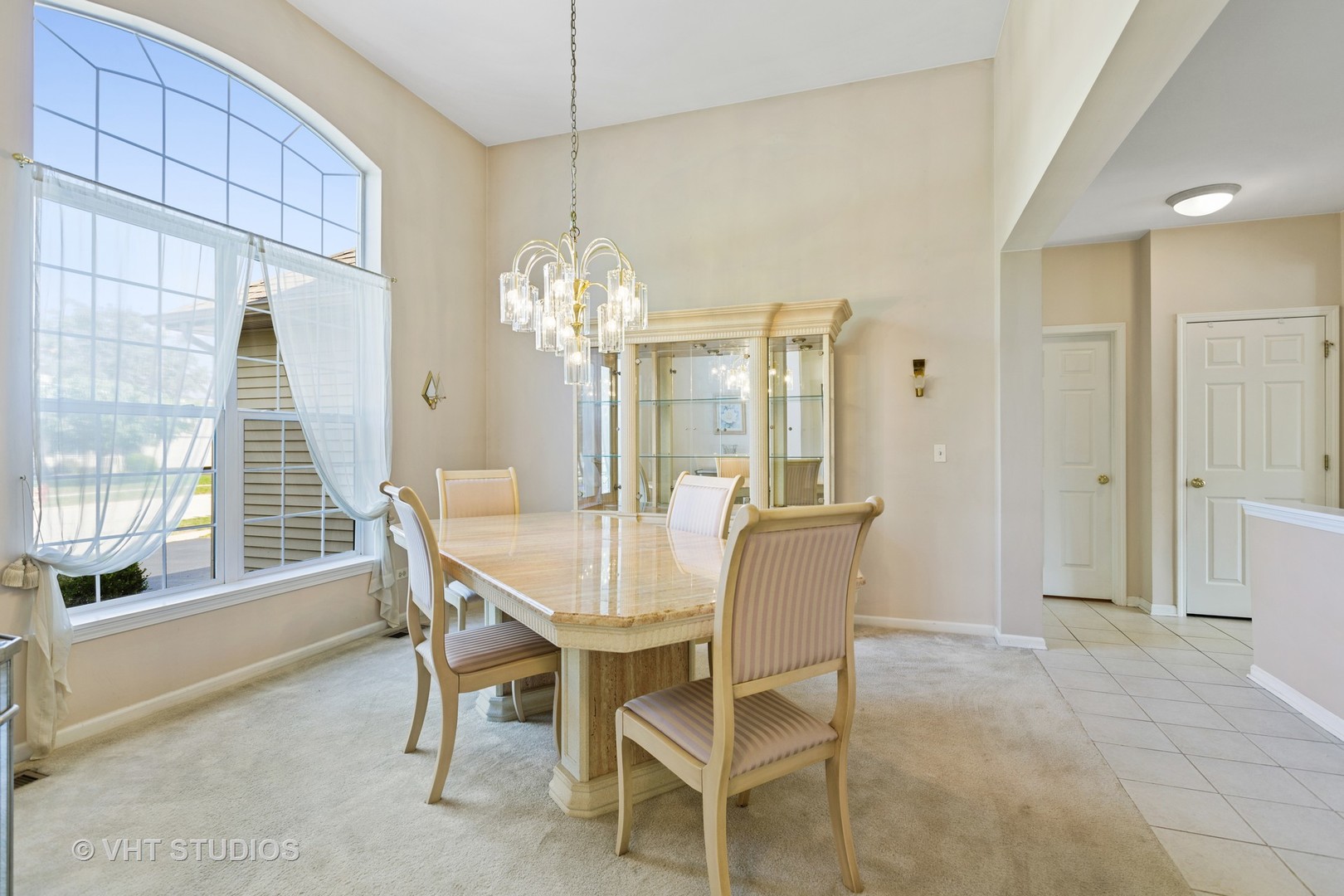 1920 Tyler Trail McHenry, IL 60051 - Photo 5 of 20 a dining room with furniture a chandelier and a rug