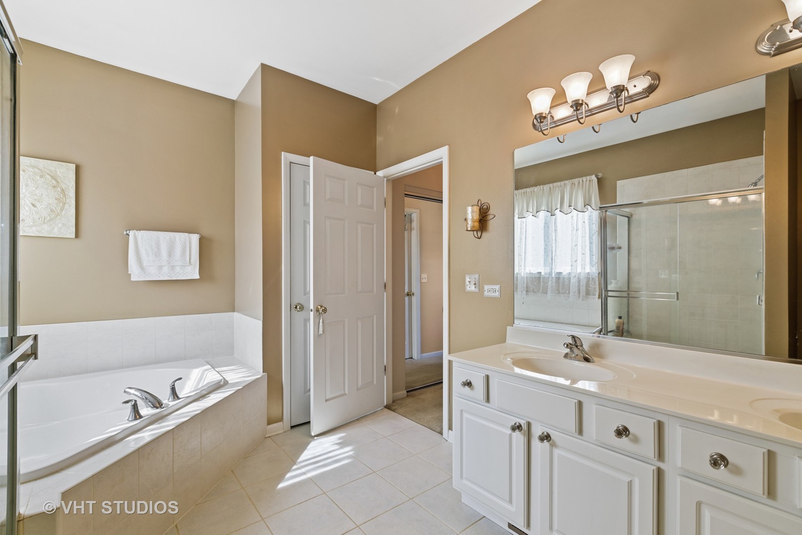 1920 Tyler Trail McHenry, IL 60051 - Photo 8 of 20 a spacious bathroom with a tub sink shower and mirror