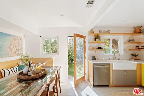 a kitchen with stainless steel appliances kitchen island granite countertop a sink and cabinets
