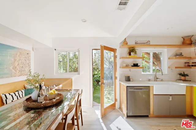 a kitchen with stainless steel appliances kitchen island granite countertop a sink and cabinets