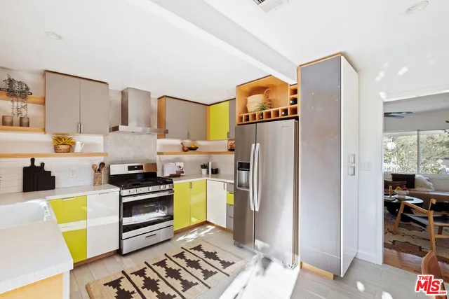 a kitchen with stainless steel appliances a refrigerator sink and stove