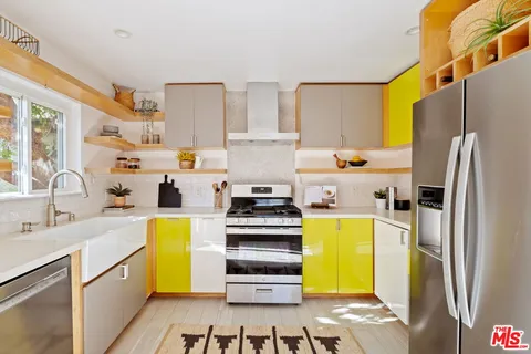 a kitchen with a refrigerator and a stove