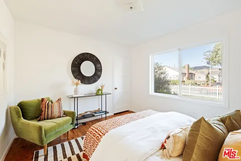 a bedroom with bed and a couch