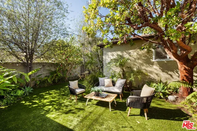 a view of a chairs and table in a yard