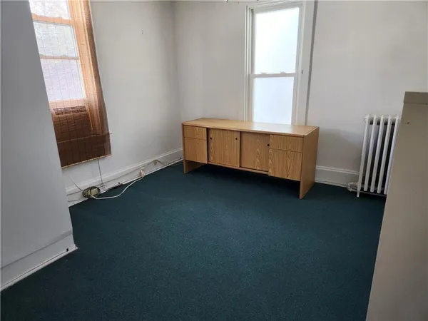 a view of room with hardwood floor and window