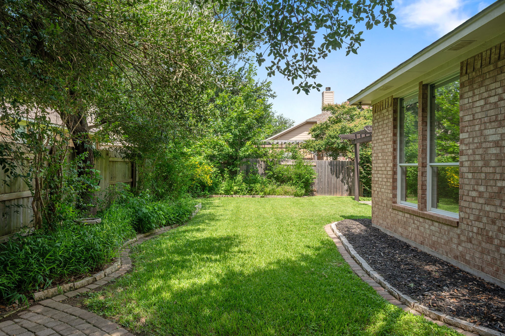 9201 La Siesta Bend Austin, TX 78749 - Photo 36 of 37 a view of a backyard with couches plants and large trees