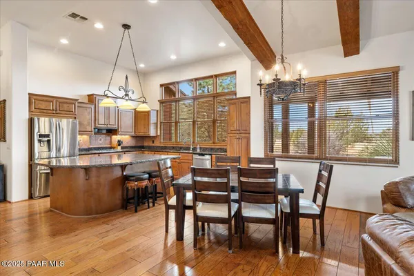 a living room with furniture a flat screen tv and a large window