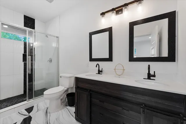 a bathroom with 2 sink and a mirror