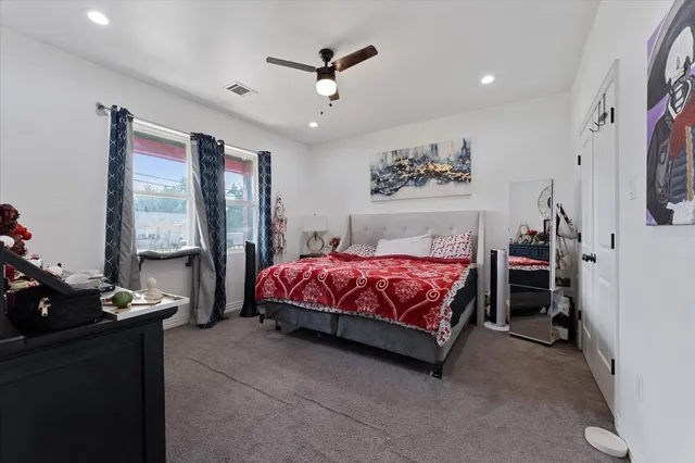 a spacious bedroom with a bed and a large window