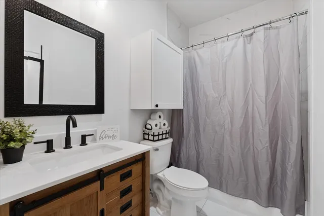 a bathroom with a toilet a sink and a mirror