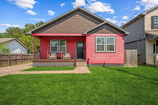 a backyard of a house with table and chairs