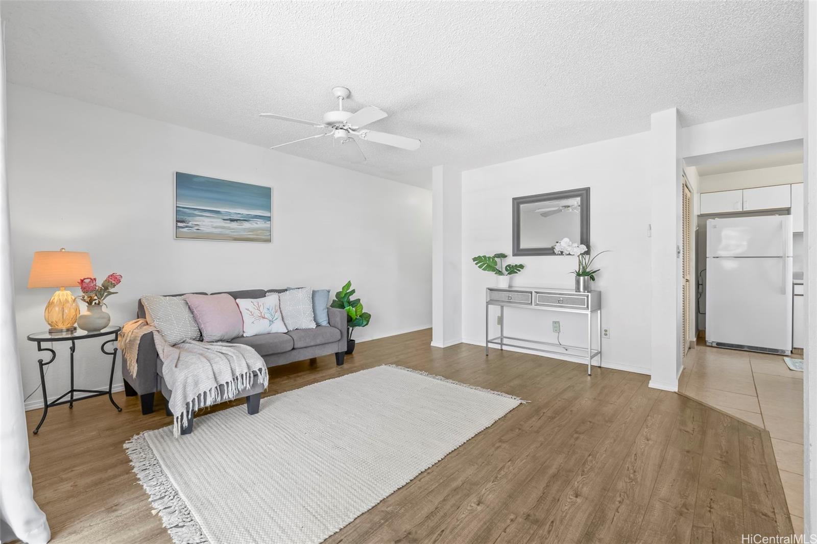 91-1008 Makaaloa Street, Unit 3E Ewa Beach, HI 96706 - Photo 11 of 21 a bed room with a bed and a chandelier