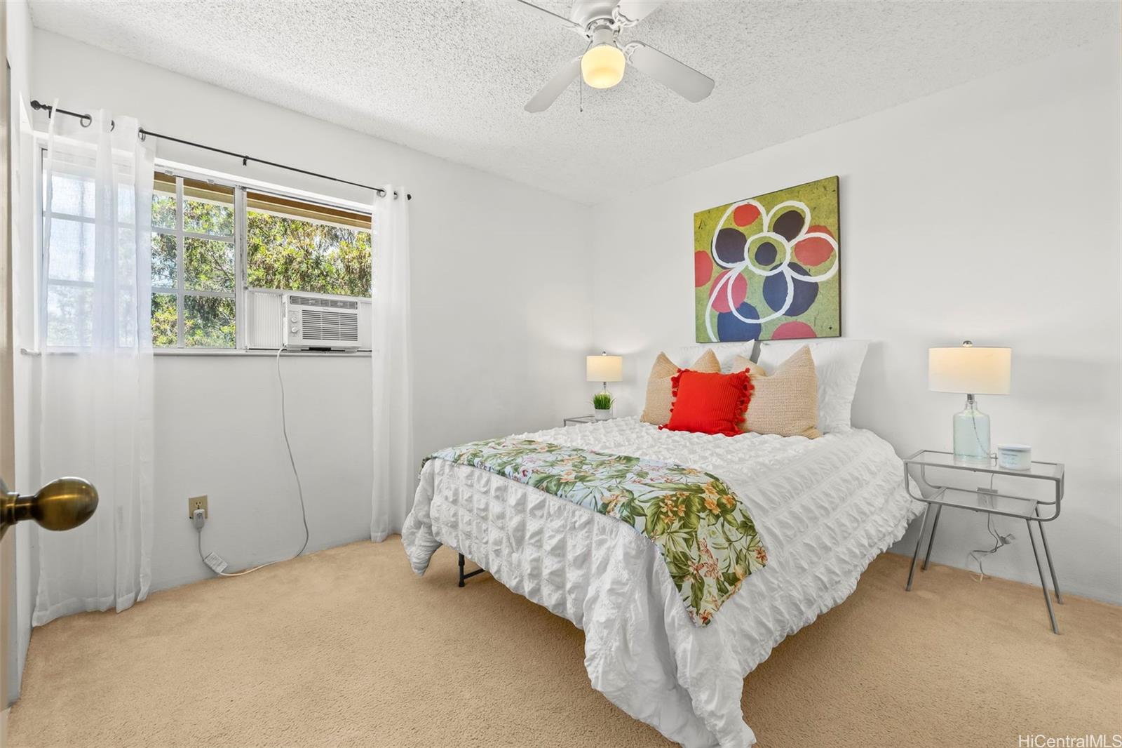 91-1008 Makaaloa Street, Unit 3E Ewa Beach, HI 96706 - Photo 13 of 21 a bedroom with a bed and a window