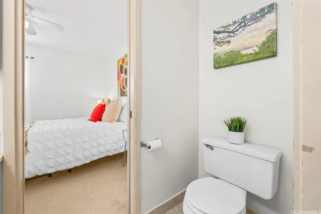 a bathroom with a sink toilet and a mirror