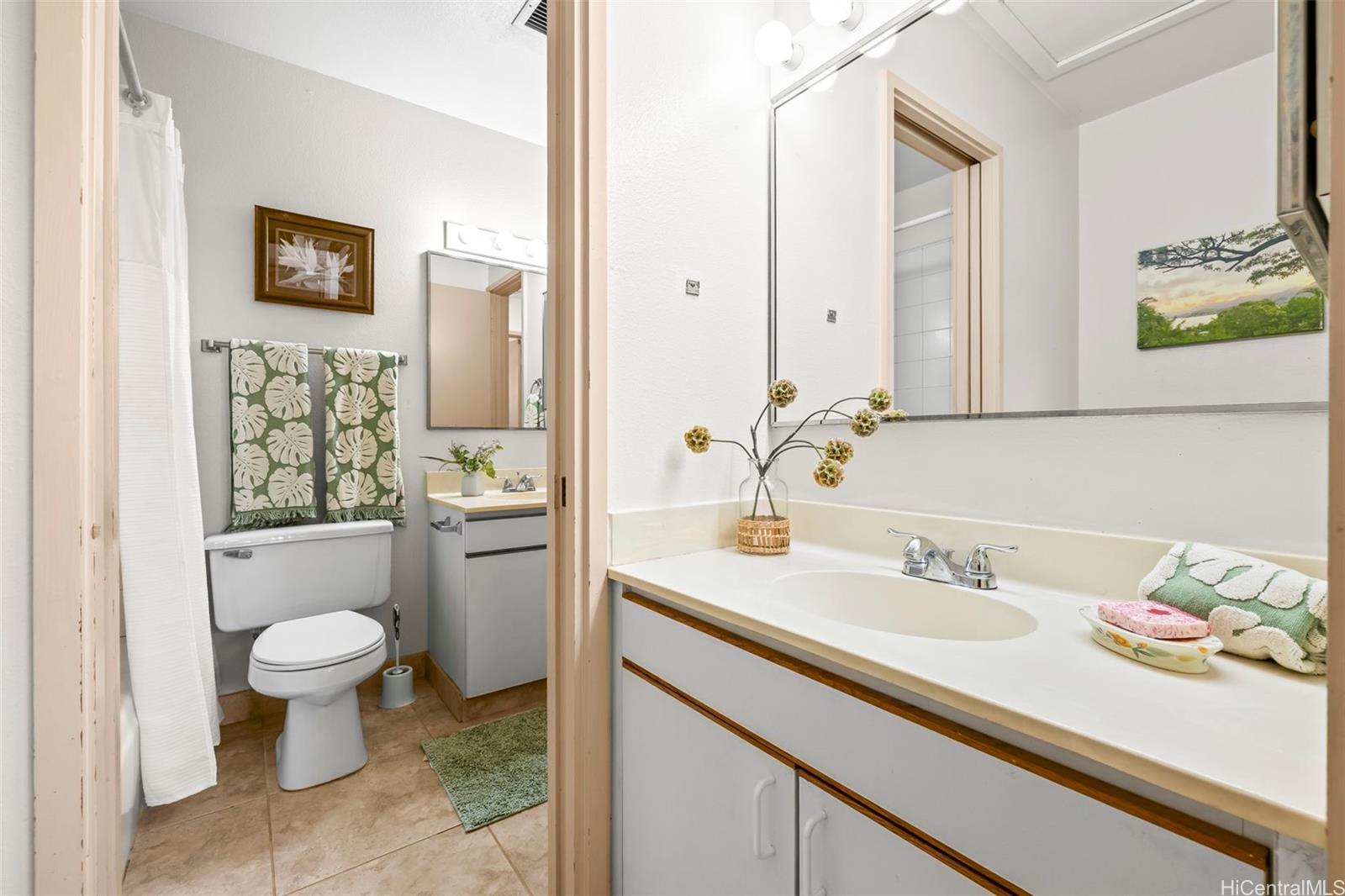 91-1008 Makaaloa Street, Unit 3E Ewa Beach, HI 96706 - Photo 15 of 21 a bathroom with a sink toilet and a mirror