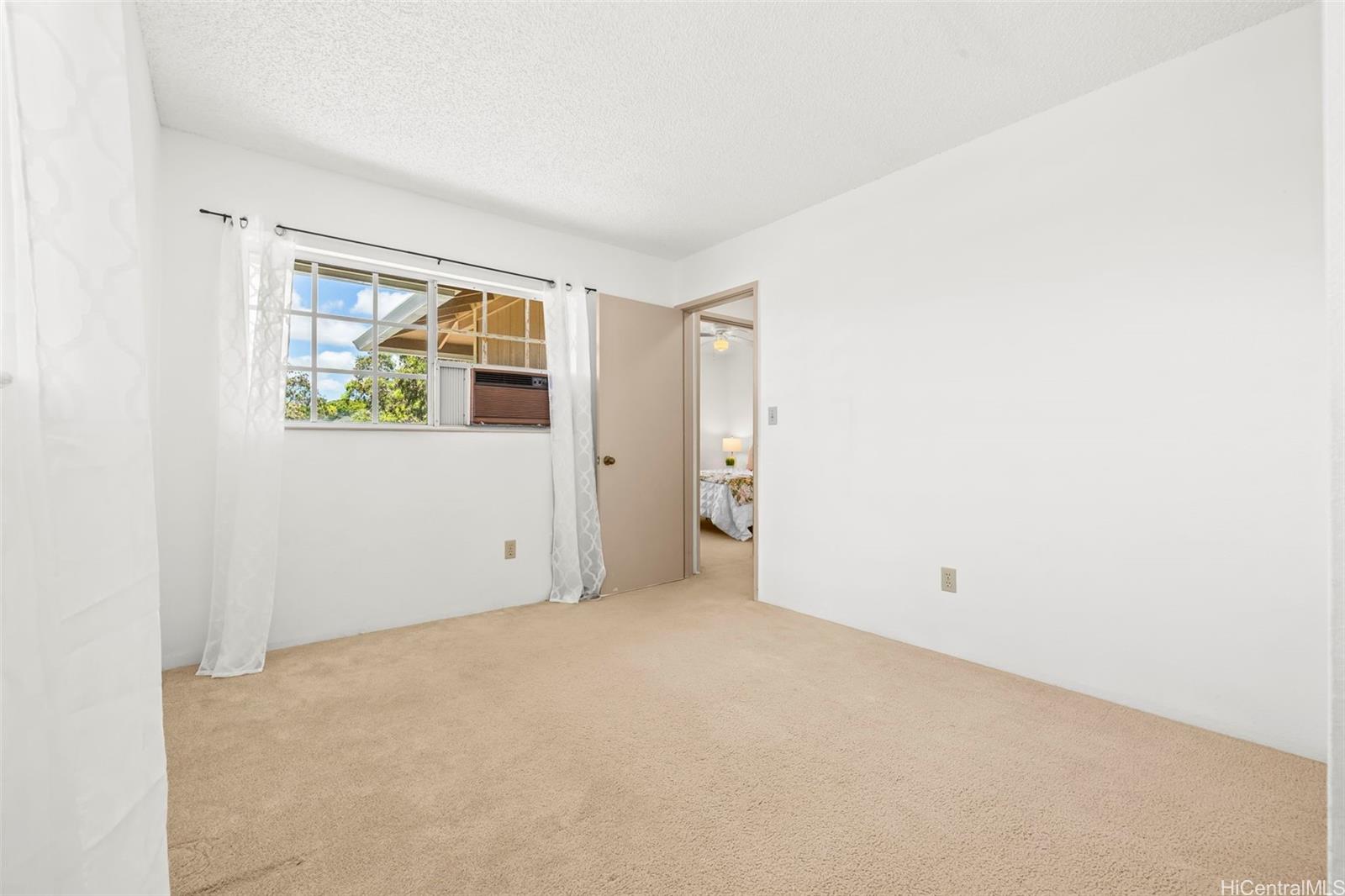 91-1008 Makaaloa Street, Unit 3E Ewa Beach, HI 96706 - Photo 16 of 21 an empty room with windows