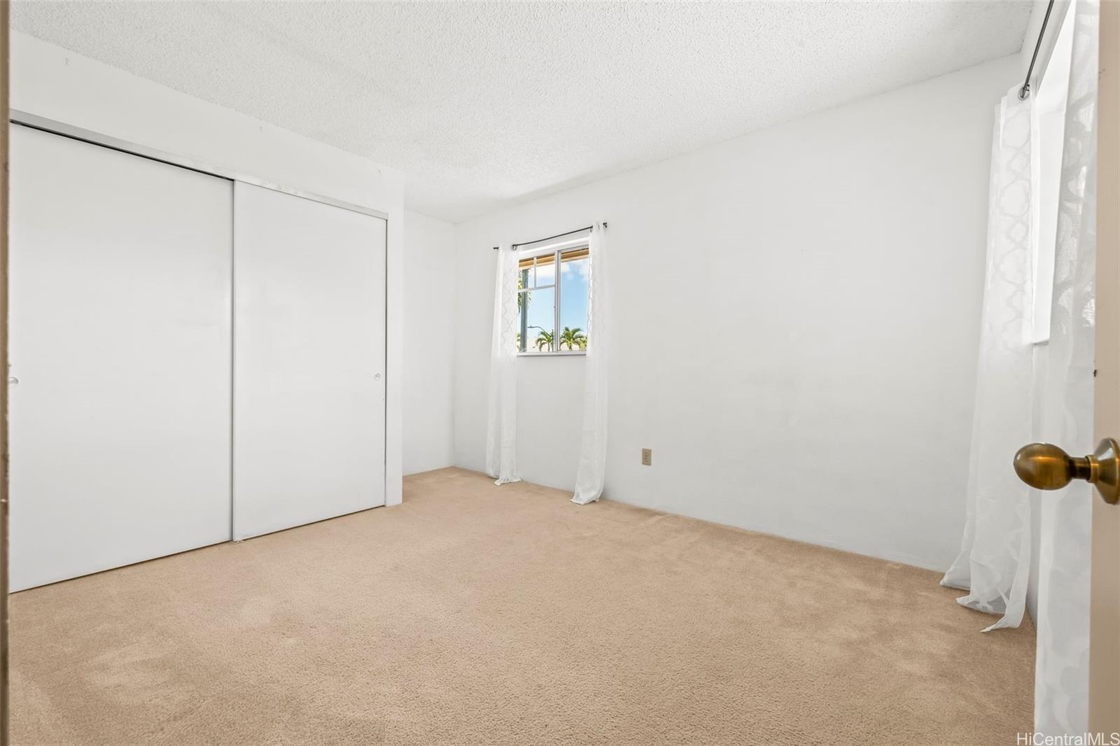 91-1008 Makaaloa Street, Unit 3E Ewa Beach, HI 96706 - Photo 17 of 21 a view of an empty room