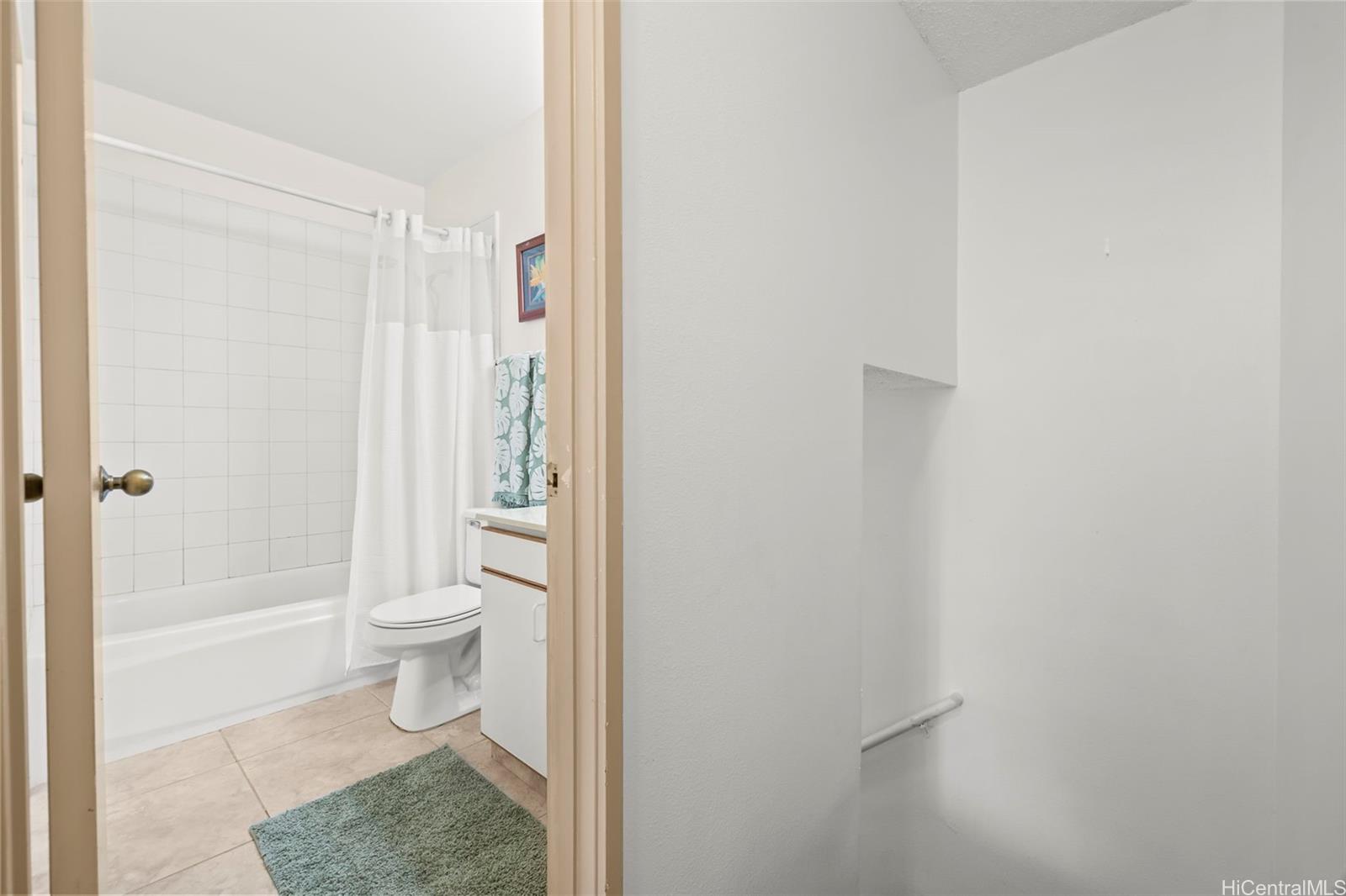 91-1008 Makaaloa Street, Unit 3E Ewa Beach, HI 96706 - Photo 19 of 21 a bathroom with a toilet and a shower