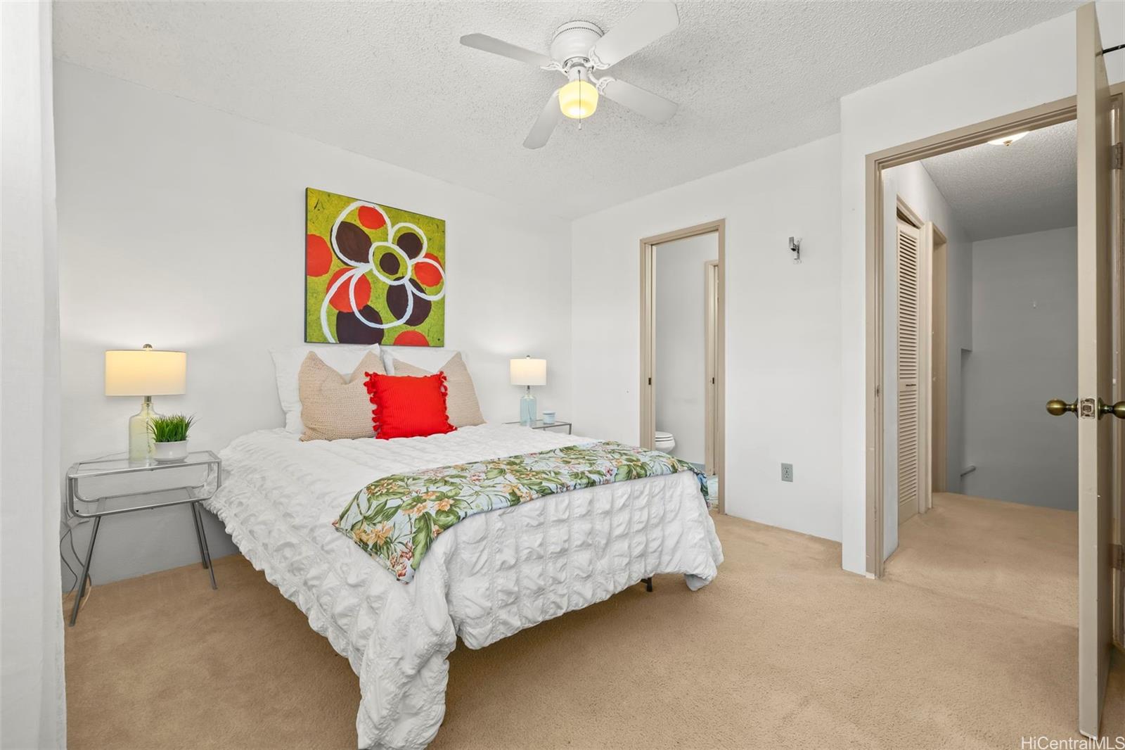 91-1008 Makaaloa Street, Unit 3E Ewa Beach, HI 96706 - Photo 3 of 21 a bedroom with a bed and painting on the wall