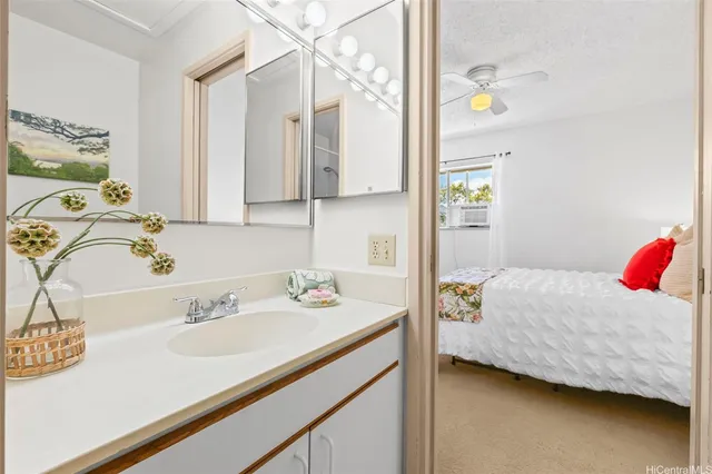 a bedroom with a bed and a sink